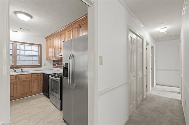 2024 Sarahs Cove Dr, Hayes, VA 23072 - kitchen with stainless steel appliances, a textured ceiling, light countertops, brown cabinetry, and ornamental molding