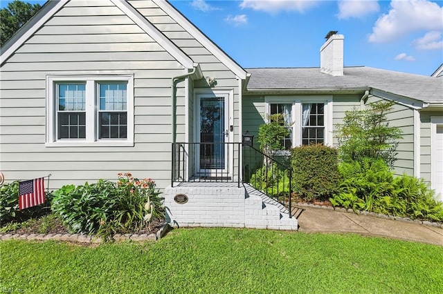 139 Chancellor Rd, Hampton, VA 23661 - view of front of home featuring a chimney and a front lawn