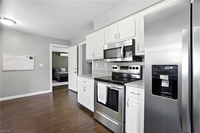 1245 Bells Mill Rd, Chesapeake, VA 23322 - kitchen with appliances with stainless steel finishes, dark wood-style flooring, white cabinets, light countertops, and a wall mounted AC