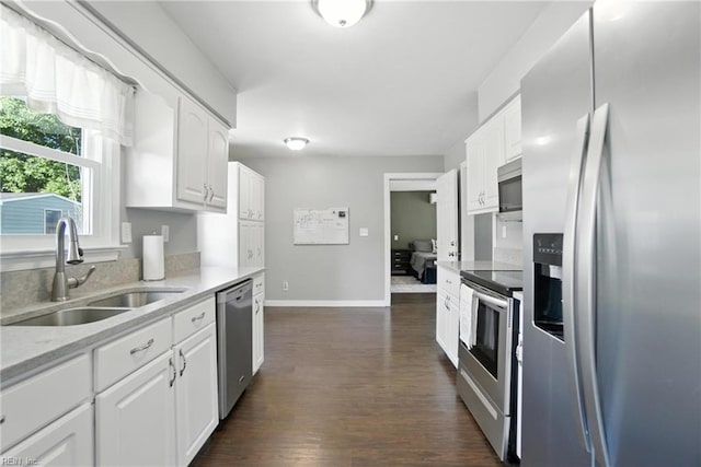 1245 Bells Mill Rd, Chesapeake, VA 23322 - kitchen with appliances with stainless steel finishes, white cabinets, dark wood-type flooring, and light stone counters