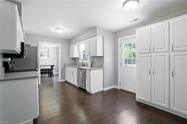 1245 Bells Mill Rd, Chesapeake, VA 23322 - kitchen with dishwasher, electric stove, white cabinets, light countertops, and dark wood-type flooring