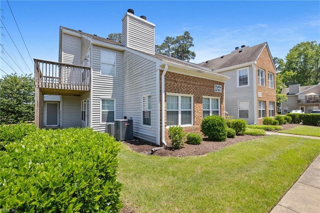 5012 Thatcher Way, Virginia Beach, VA 23456 - back of property with a chimney, a lawn, brick siding, and a balcony