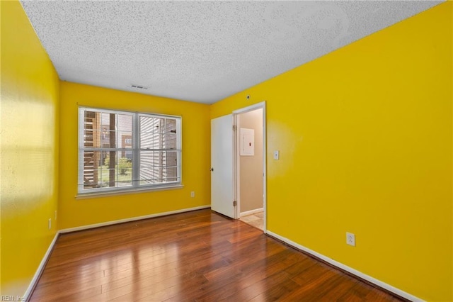 5012 Thatcher Way, Virginia Beach, VA 23456 - empty room featuring a textured ceiling and wood finished floors