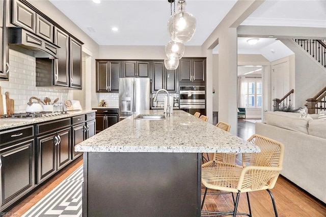 113 Saint Andrews, Smithfield, VA 23430 - kitchen featuring stainless steel appliances, a breakfast bar, light wood-style floors, light stone countertops, and recessed lighting