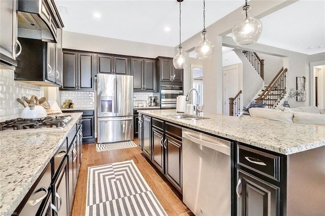 113 Saint Andrews, Smithfield, VA 23430 - kitchen featuring appliances with stainless steel finishes, light wood finished floors, decorative backsplash, premium range hood, and pendant lighting