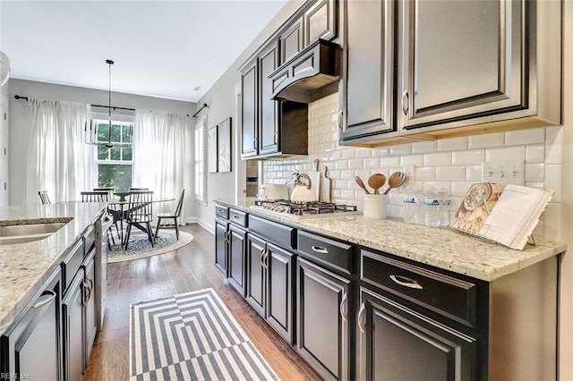 113 Saint Andrews, Smithfield, VA 23430 - kitchen with stainless steel gas cooktop, light wood-style floors, backsplash, custom range hood, and light stone counters