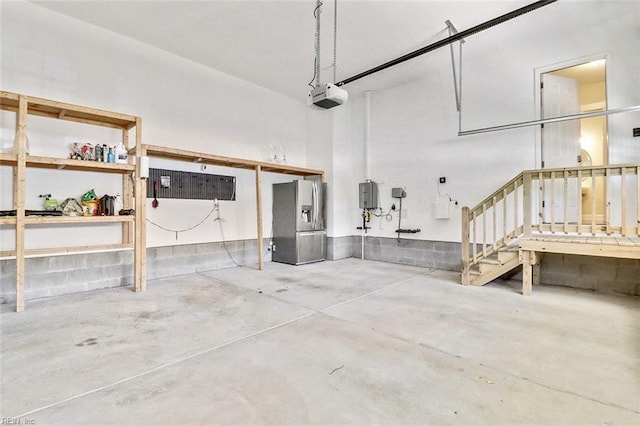 113 Saint Andrews, Smithfield, VA 23430 - garage featuring stainless steel fridge and a garage door opener