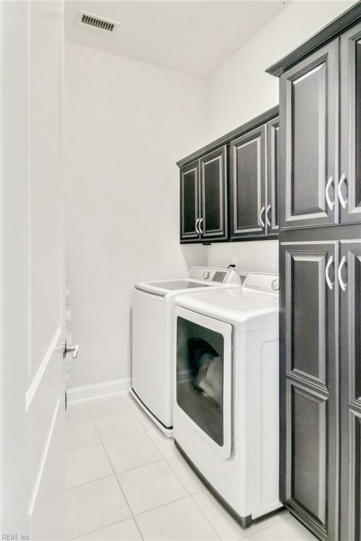 113 Saint Andrews, Smithfield, VA 23430 - laundry room with cabinet space, washing machine and clothes dryer, and light tile patterned floors