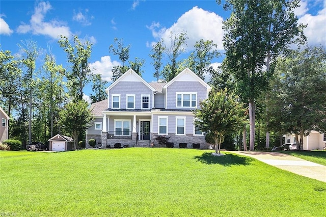 113 Saint Andrews, Smithfield, VA 23430 - craftsman-style home featuring stone siding, a front lawn, an outbuilding, and driveway