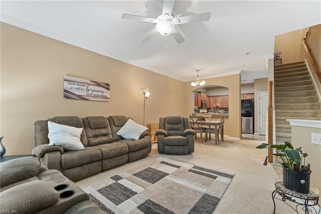 507 Marsh Hawk Trl, Carrollton, VA 23314 - living room featuring light carpet, stairs, a chandelier, a ceiling fan, and crown molding