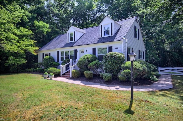 8579 Farys Mill Rd, Gloucester, VA 23061 - cape cod-style house featuring a front lawn, view of wooded area, and roof with shingles