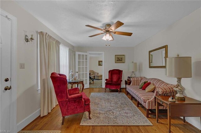8579 Farys Mill Rd, Gloucester, VA 23061 - living area featuring a ceiling fan, wood finished floors, and a textured ceiling