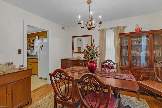 8579 Farys Mill Rd, Gloucester, VA 23061 - dining room with a chandelier and light wood-type flooring