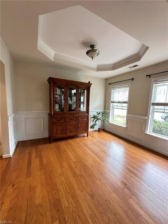 5837 Flowering Peach Ln, Providence Forge, VA 23140 - foyer featuring a tray ceiling, plenty of natural light, crown molding, wainscoting, and light wood-style flooring