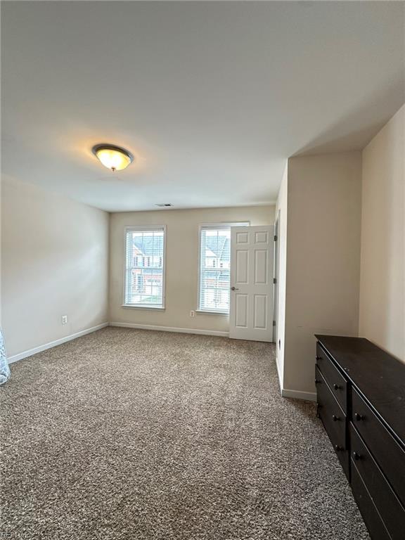 5837 Flowering Peach Ln, Providence Forge, VA 23140 - unfurnished bedroom featuring carpet floors and baseboards