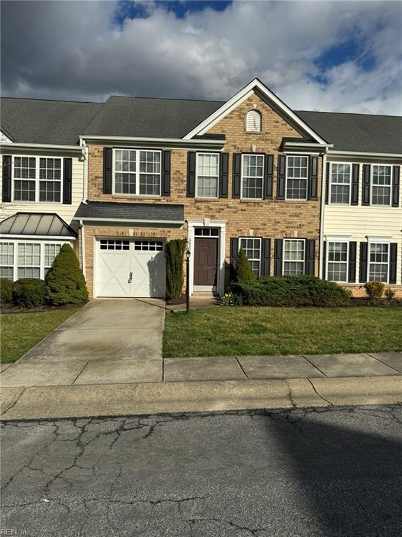 5837 Flowering Peach Ln, Providence Forge, VA 23140 - view of front of house featuring concrete driveway, brick siding, a garage, and a front lawn