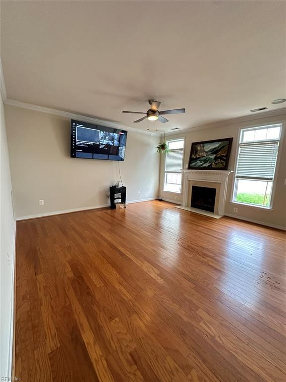5837 Flowering Peach Ln, Providence Forge, VA 23140 - unfurnished living room with ornamental molding, wood finished floors, ceiling fan, and a fireplace