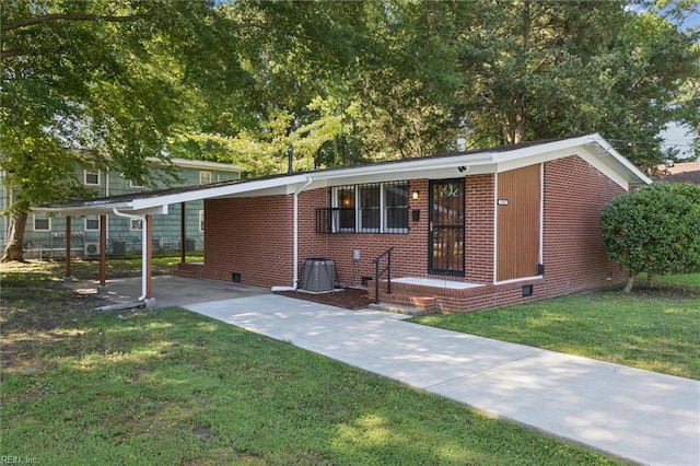 2734 Jamestown Ave, Hampton, VA 23661 - view of front of home with brick siding, a carport, a front yard, driveway, and crawl space