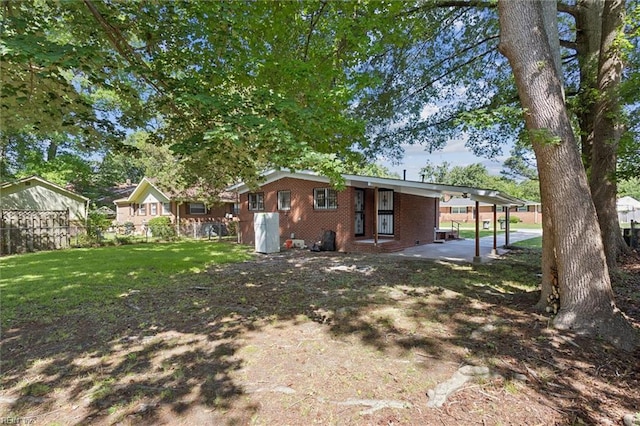2734 Jamestown Ave, Hampton, VA 23661 - rear view of property with brick siding and an attached carport