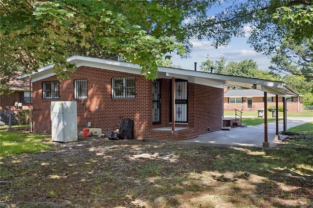 2734 Jamestown Ave, Hampton, VA 23661 - back of house featuring brick siding and an attached carport