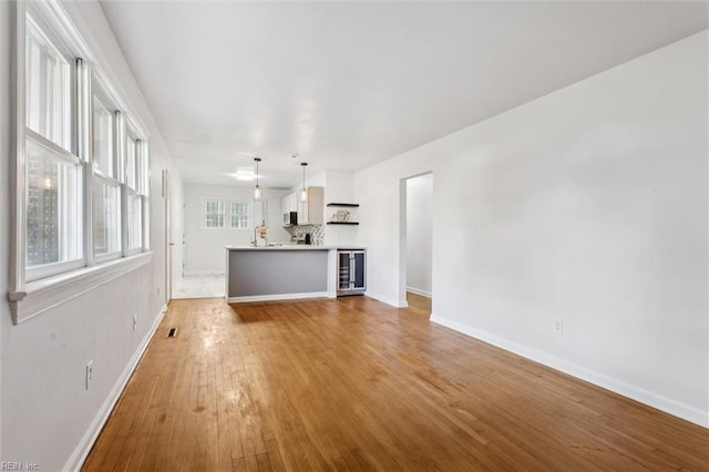 2734 Jamestown Ave, Hampton, VA 23661 - unfurnished living room featuring wood-type flooring and beverage cooler