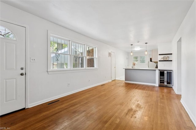 2734 Jamestown Ave, Hampton, VA 23661 - unfurnished living room featuring beverage cooler and light wood finished floors