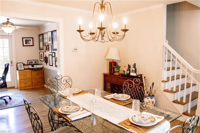3728 Sidley Rd, Chesapeake, VA 23321 - dining area featuring wood finished floors, crown molding, stairs, a ceiling fan, and a chandelier