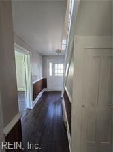 1697 Old Ferry Rd, Hudgins, VA 23076 - hall with dark wood-style floors and wainscoting
