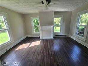 1697 Old Ferry Rd, Hudgins, VA 23076 - unfurnished living room featuring plenty of natural light, wood finished floors, and a baseboard heating unit