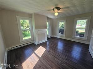 1697 Old Ferry Rd, Hudgins, VA 23076 - unfurnished living room with a ceiling fan, dark wood-style floors, and a baseboard radiator