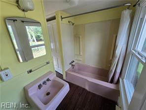 1697 Old Ferry Rd, Hudgins, VA 23076 - bathroom featuring shower / bath combo and wood finished floors