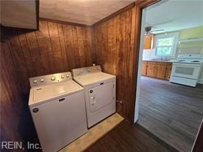 1697 Old Ferry Rd, Hudgins, VA 23076 - laundry room with washer and clothes dryer, wooden walls, dark wood-style flooring, and ceiling fan