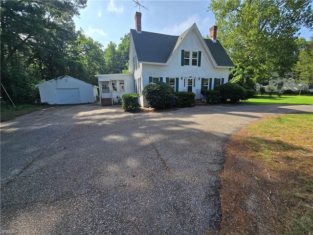 1697 Old Ferry Rd, Hudgins, VA 23076 - view of front of home featuring a chimney, driveway, an outdoor structure, and a garage