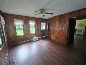 1697 Old Ferry Rd, Hudgins, VA 23076 - unfurnished living room featuring wooden walls, a ceiling fan, and dark wood-style floors