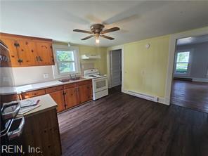 1697 Old Ferry Rd, Hudgins, VA 23076 - kitchen featuring white stove, dark wood finished floors, a ceiling fan, and plenty of natural light