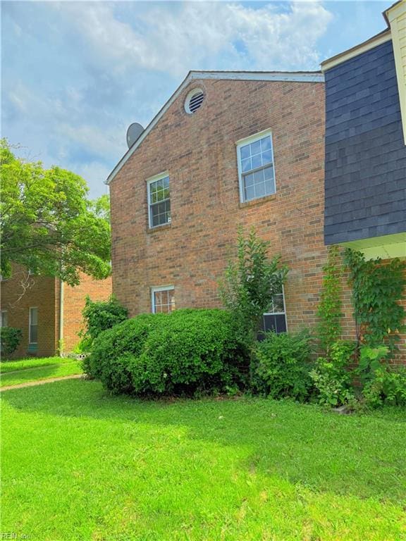 5813 W Hastings Arch, Virginia Beach, VA 23462 - view of side of property with a lawn and brick siding