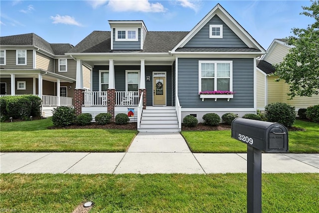 3209 Dodd Dr, Chesapeake, VA 23323 - view of front of property featuring covered porch, a front lawn, and roof with shingles