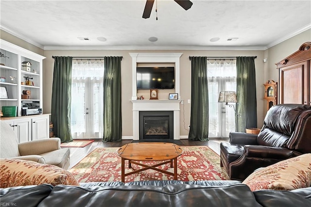 3209 Dodd Dr, Chesapeake, VA 23323 - living room with healthy amount of natural light, a ceiling fan, wood finished floors, ornamental molding, and a glass covered fireplace