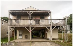 800 W Durham St, Kill Devil Hills, NC 27948 - view of front of property with a carport, asphalt driveway, and a wooden deck