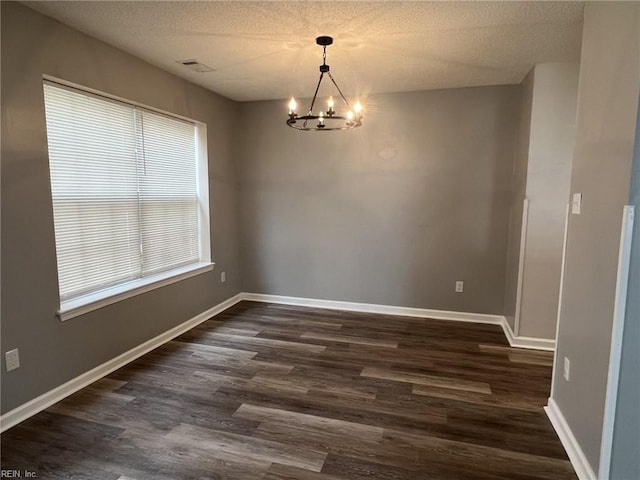 12803 Daybreak Cir, Newport News, VA 23602 - empty room featuring a chandelier, dark wood-style flooring, and a textured ceiling