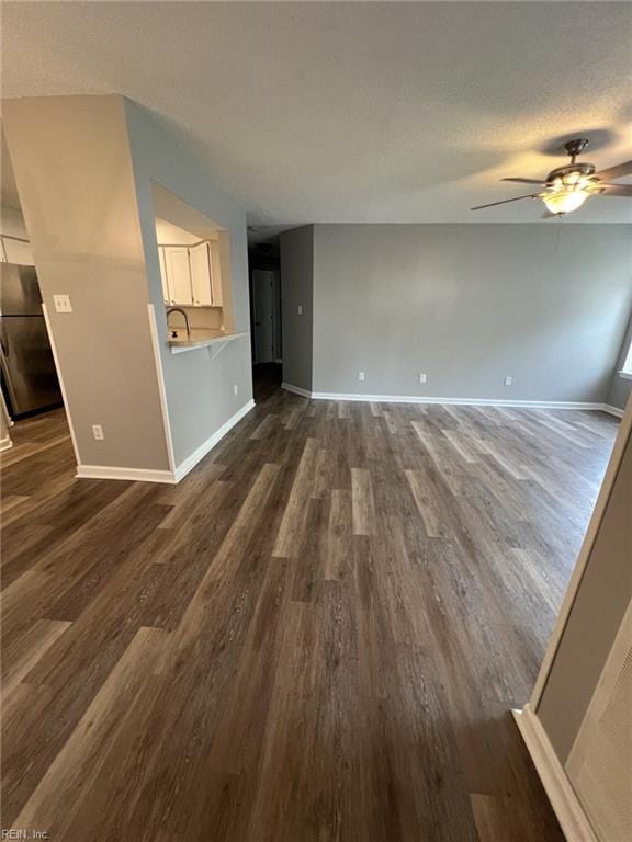 12803 Daybreak Cir, Newport News, VA 23602 - unfurnished living room featuring ceiling fan, dark wood finished floors, and a textured ceiling
