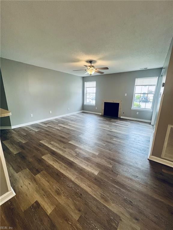 12803 Daybreak Cir, Newport News, VA 23602 - unfurnished living room featuring a ceiling fan, dark wood finished floors, and a textured ceiling