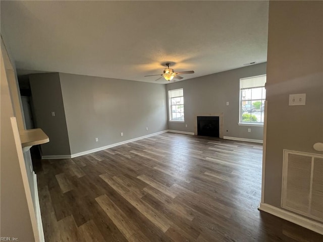 12803 Daybreak Cir, Newport News, VA 23602 - unfurnished living room with a ceiling fan, dark wood-type flooring, and a fireplace