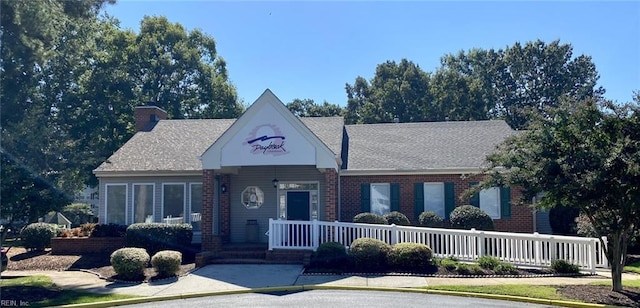 12803 Daybreak Cir, Newport News, VA 23602 - view of front facade with brick siding, a chimney, and a porch