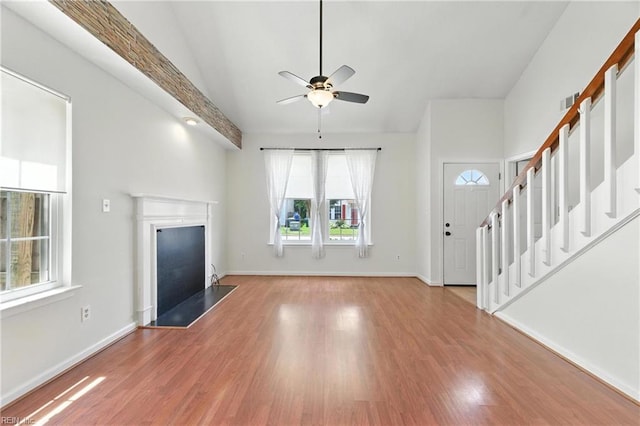 182 Old Bridge Rd, Newport News, VA 23608 - unfurnished living room featuring ceiling fan, wood finished floors, lofted ceiling, a fireplace, and stairs