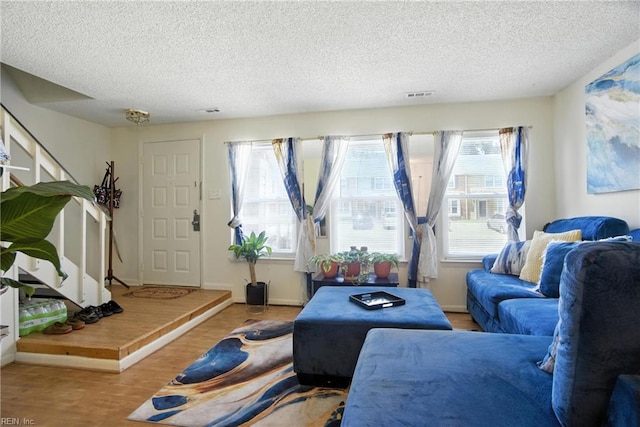 5523 Keydet Dr, Virginia Beach, VA 23462 - living room featuring a textured ceiling, healthy amount of natural light, stairs, and wood finished floors
