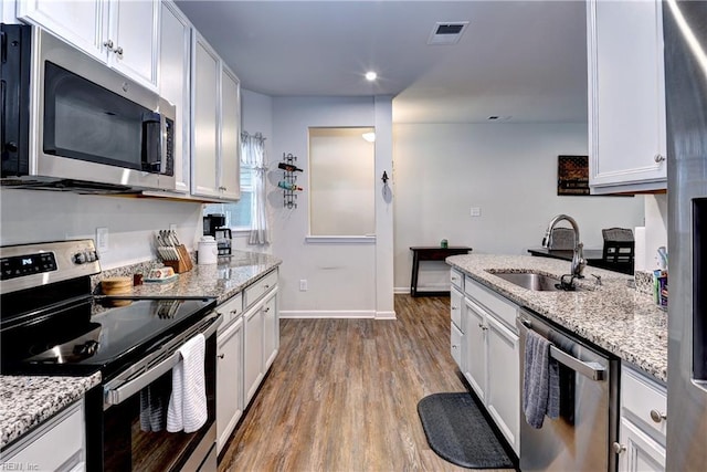 3419 Foxglove Dr, Toano, VA 23168 - kitchen featuring stainless steel appliances, wood finished floors, white cabinetry, light stone counters, and recessed lighting