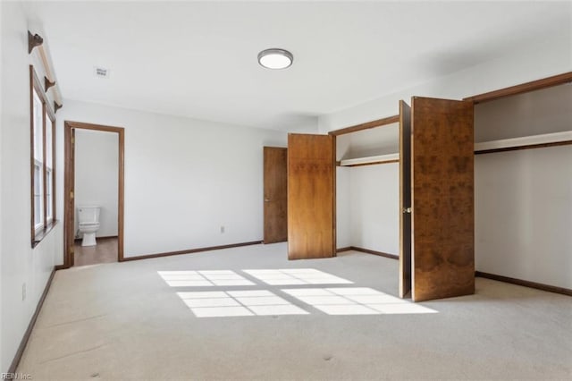 112 Farmington Blvd, Hampton, VA 23666 - unfurnished bedroom featuring light carpet, two closets, and ensuite bathroom