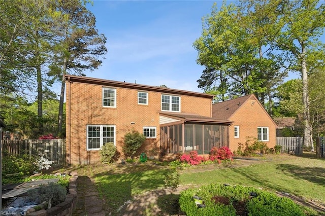 112 Farmington Blvd, Hampton, VA 23666 - rear view of house with a sunroom, brick siding, and a fenced backyard