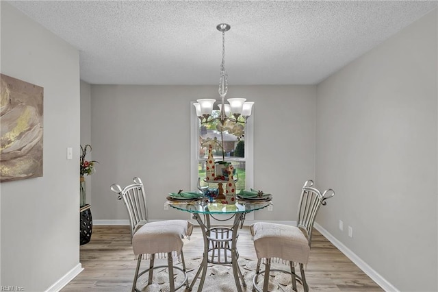3905 Stonebridge Ct, Chesapeake, VA 23321 - dining space featuring wood finished floors, a chandelier, and a textured ceiling